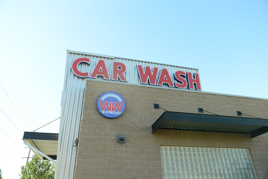 The CAR WASH sign and WaterWorks Express roundel on the block wall of the 9000 South location in West Jordan.