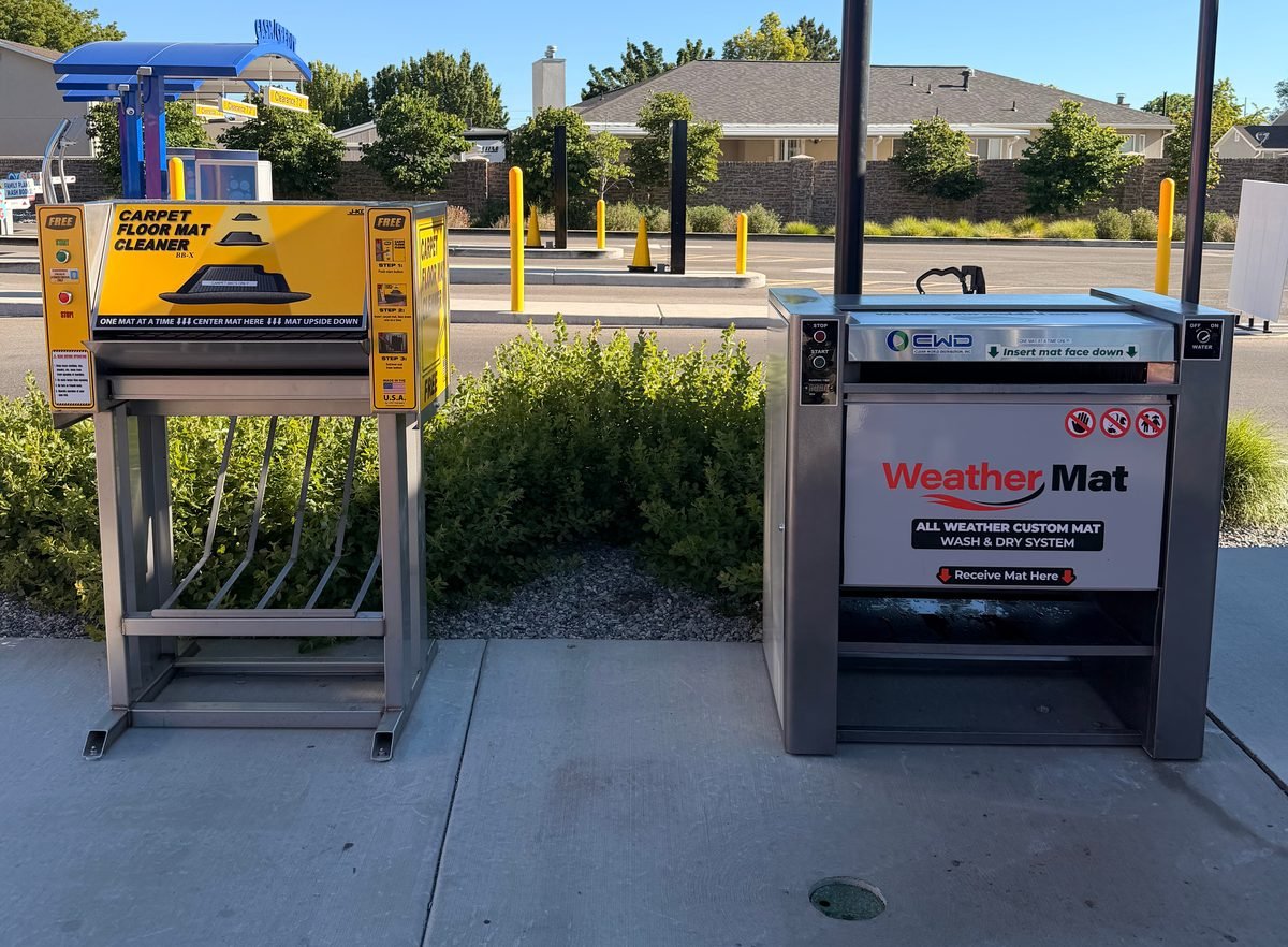 Two free mat cleaning machines at WaterWorks Express 7800 South: a yellow carpet floor mat cleaner and a stainless WeatherMat all-weather mat wash and dry system.